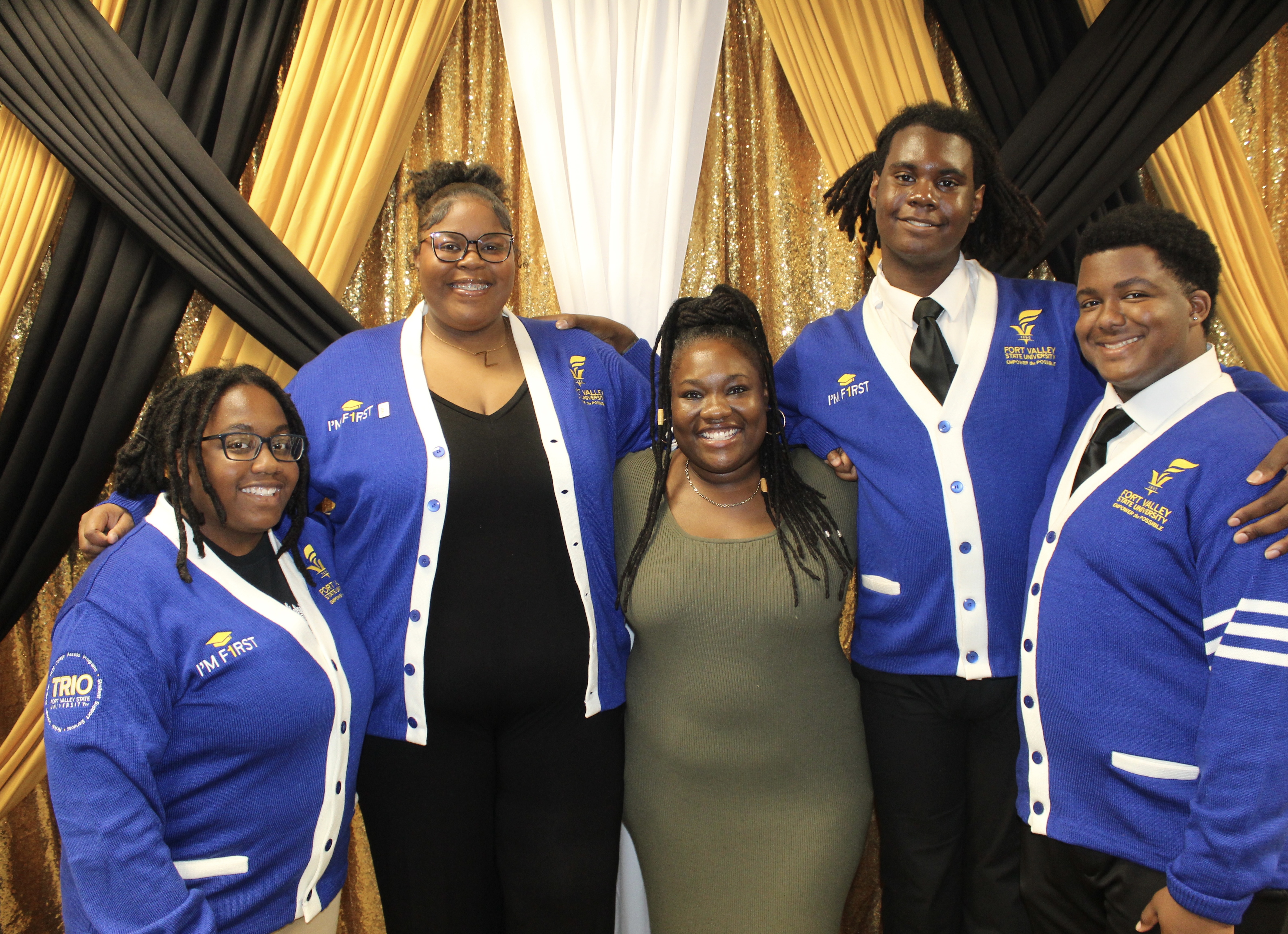 Group of students standing together and embracing each other.